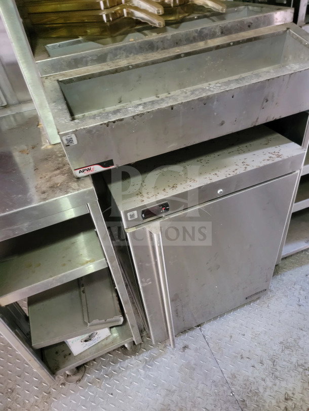Rock Solid Cargo 8.5' x 24' mobile kitchen trailer interior with stainless steel equipment, True refrigeration, and APW branding.