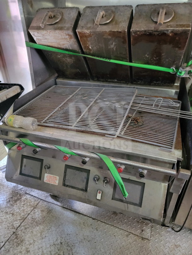 Rock Solid Cargo trailer kitchen interior showing a cooking grill setup with three covered compartments and control panel.