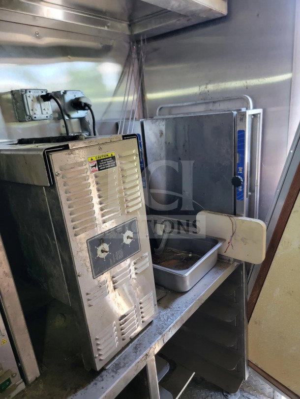 2021 Rock Solid Cargo 8.5' x 24' mobile kitchen trailer interior with appliances; visible wear; stainless steel surfaces.
