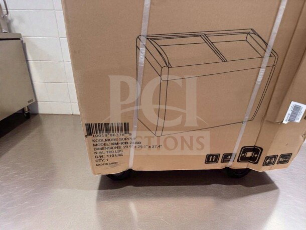 Brand new KoolMore KM-ICD-26SD ice cream dipping cabinet, 6 cu. ft., UL listed, in original box with model details and specs.