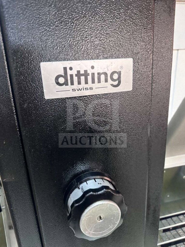 Ditting KR1203 coffee grinder in excellent condition, features adjustable grind settings, Swiss made, model sign visible.