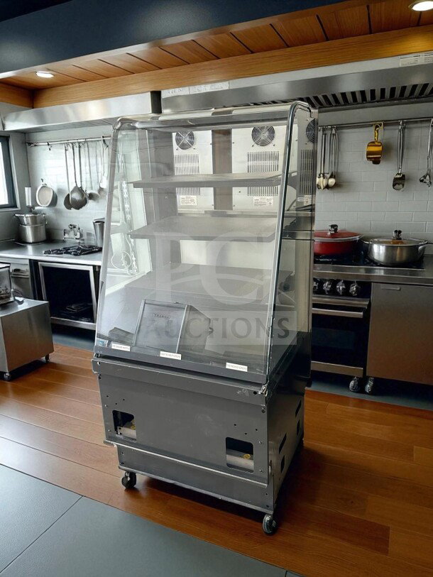 Curved Glass Refrigerated Display Case, excellent condition, 4 adjustable shelves, 115V, UL Listed, fully tested, on wheels.