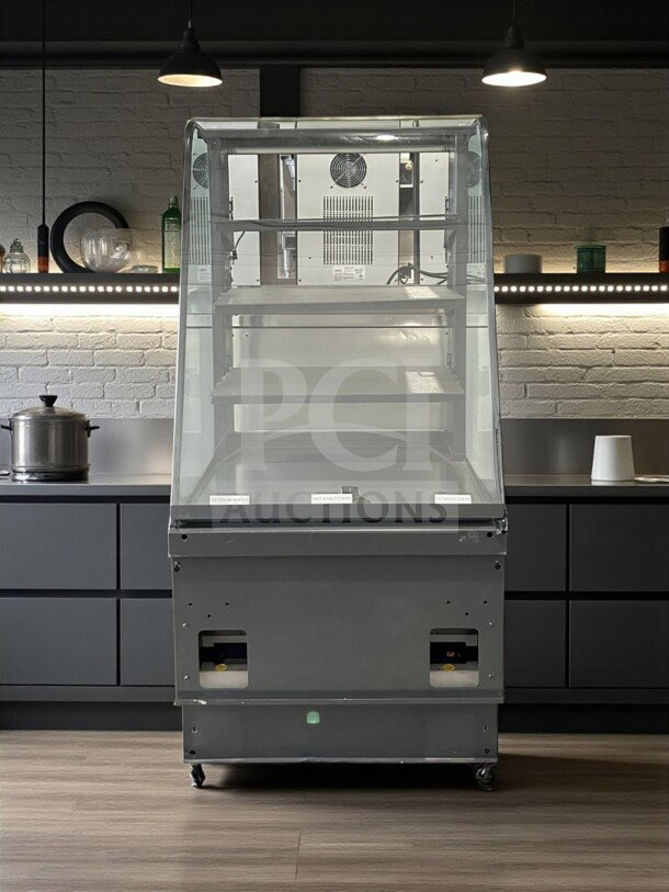 Curved glass refrigerated display case, excellent condition, 4 adjustable shelves, 115V, UL listed, tested, commercial use.