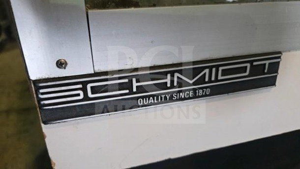 The C. Schmidt EHD-4 display case, curved glass, "Quality Since 1870" label, impeccable condition, 115V operational.