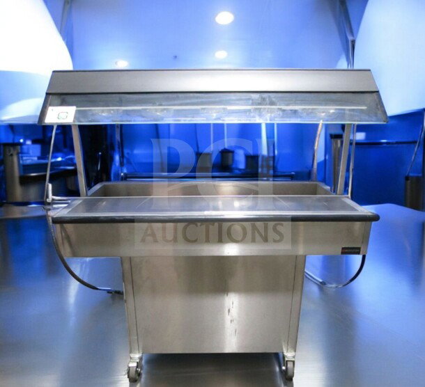 Duke E304 4-well commercial electric steam table in very good condition with sneeze guard, tested and operational, 208V.