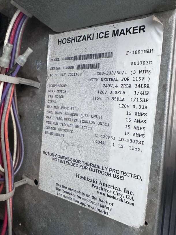 Label on Hoshizaki E-1001MAH Ice Maker, showing model and serial number. Lists voltage, compressor specs, and other details.
