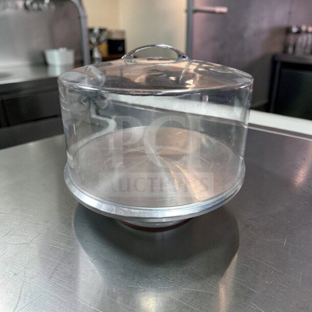 Acrylic cake display dome with stainless steel base, 12" diameter, premium condition, ideal for commercial bakery use.