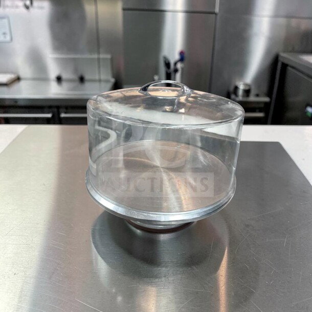 Premium acrylic cake display dome with stainless steel base, 12" diameter, in excellent condition. Model: CAKE-S-DOME-0792.