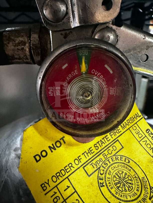 Pyro-Chem KS-6100 Class K fire extinguisher, UL Listed, fully inspected. Yellow tag indicates state fire marshal approval.