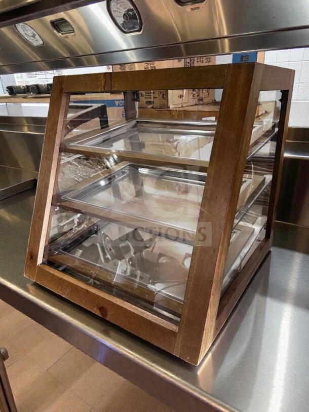 Remarkable condition 2-tier wooden countertop pastry display case with glass panels. Fully tested and operational. Model WDC-S-DSP-0988.