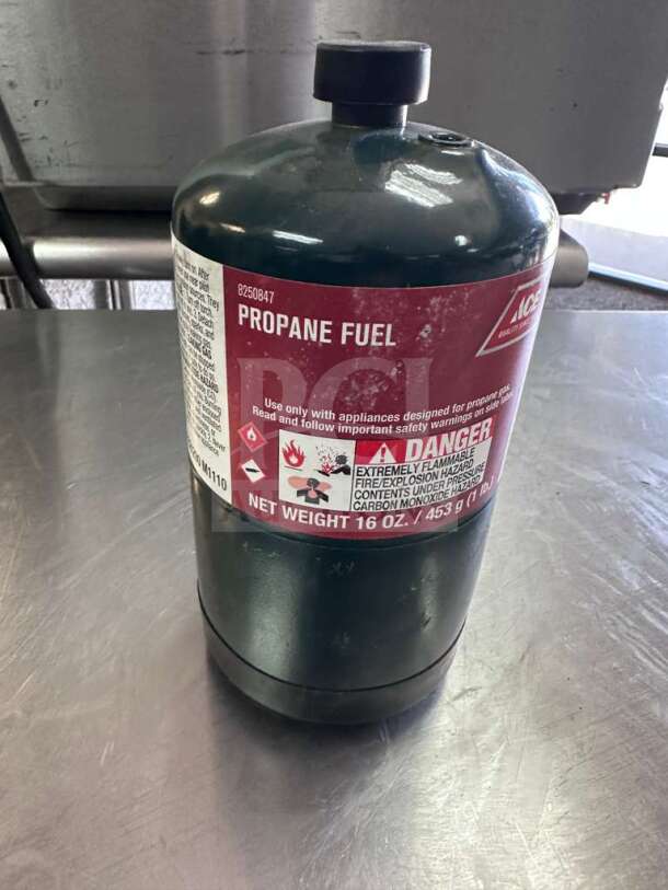 Ace Hardware 16 oz steel propane fuel cylinder in exceptional condition, labeled for propane use, ideal for camping and heating.