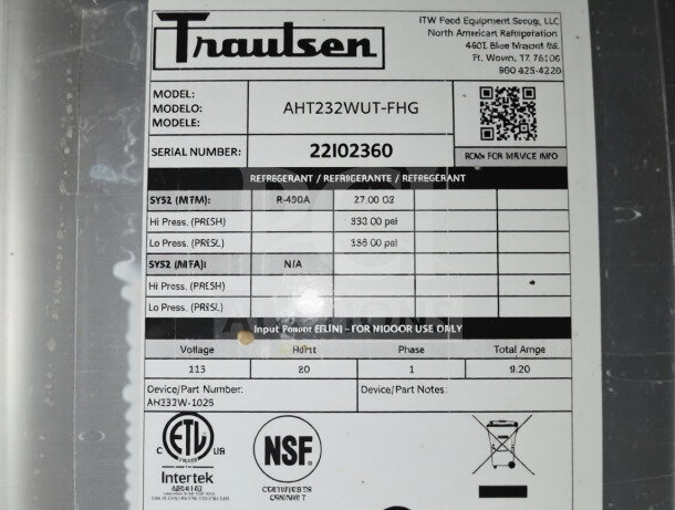 Label on Traulsen RHT232WUT-FHG refrigerator showing model, serial number 22102360, voltage 113V, and ETL/NSF logos.