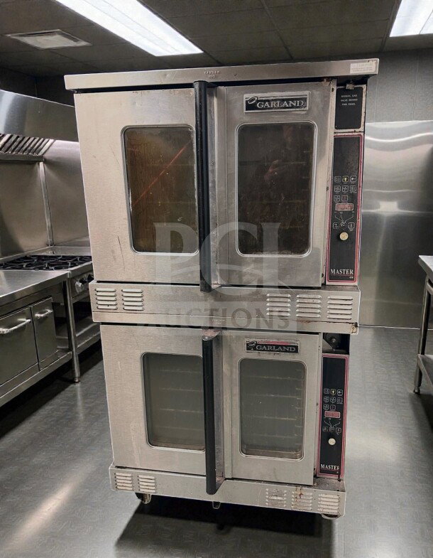 Two Garland Master 450 gas convection ovens, stainless steel, full-size, excellent condition, fully operational, 120V/gas.