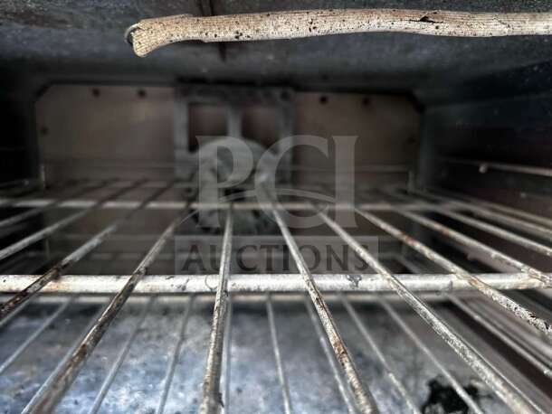 Interior view of Vulcan 36C-2B24GTN convection oven, showing metal racks and fan. Oven is fully operational and NSF/CSA listed.