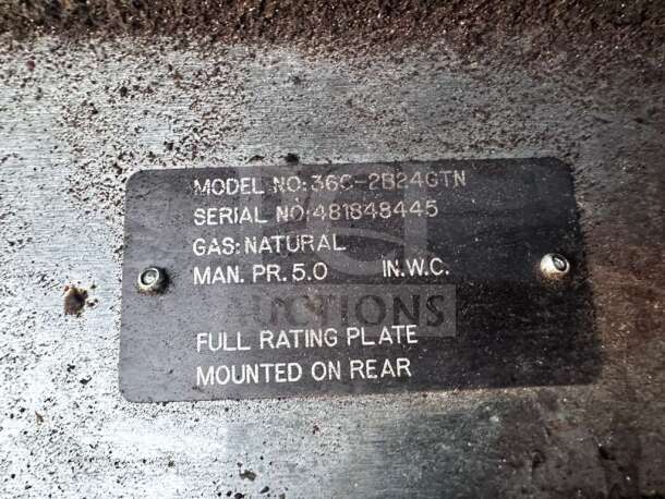 Metal rating plate showing Vulcan 36C-2B24GTN model details, natural gas type, and serial number 4818484845.