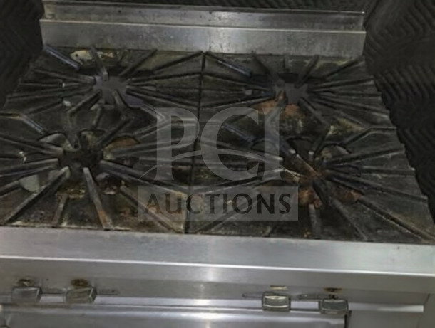 Montague 136-5A Legend 36" gas range, four 18" open burners, standard oven base, 160,000 BTU, heavy-duty, well-maintained.