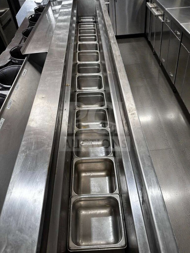 Stainless steel wok cooking line with refrigerated top, 6 burners, gas operation, immaculate condition, fully tested.