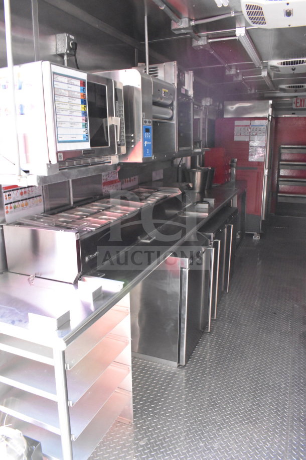 2022 Rock Solid Cargo 8.5x28 food trailer interior with stainless steel kitchen equipment, refrigeration, and industrial shelving.