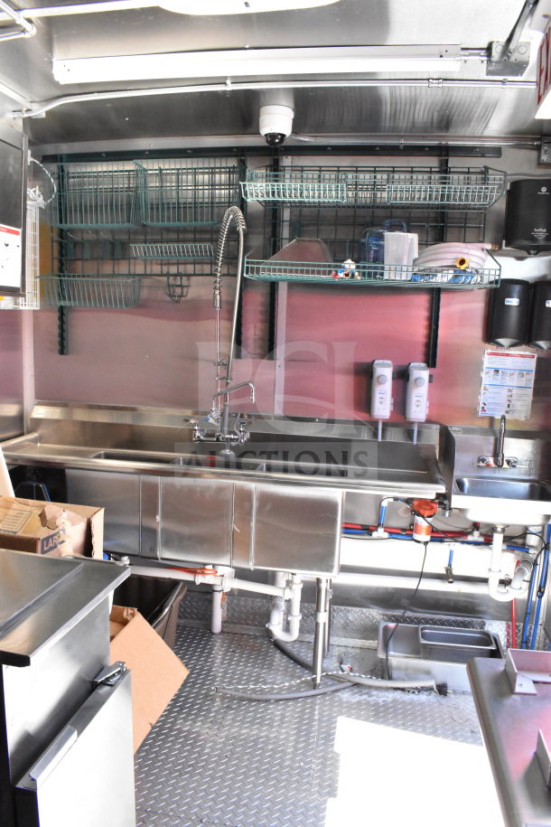 2022 Rock Solid Cargo 8.5x28 food trailer interior, stainless steel sink, shelving, and equipment; excellent condition.