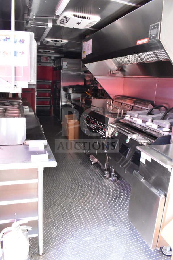2022 Rock Solid Cargo 8.5x28 food trailer interior, featuring stainless steel counters, commercial kitchen equipment, and CaptiveAire ventilation.