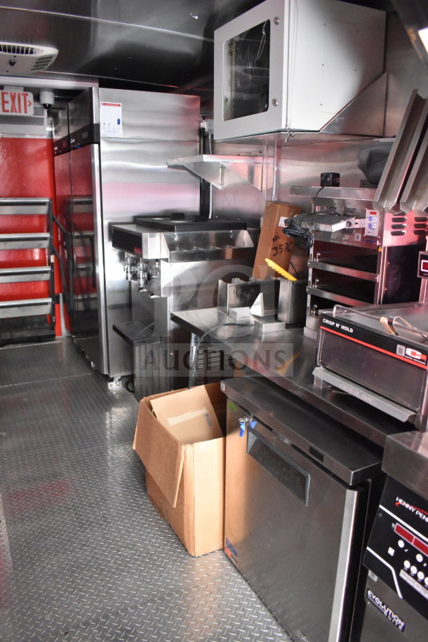 2022 Rock Solid Cargo 8.5x28 food trailer interior. Stainless appliances, storage, and equipment visible. Clean condition.