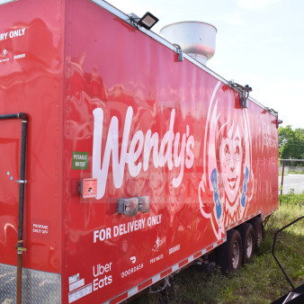 Red Wendy's food trailer with branding, dual axles, and a propane shut off. Labeled for delivery use only.