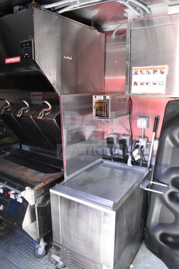 Wendy's food trailer interior with stainless steel countertops, CaptiveAire ventilation system, and professional kitchen equipment.