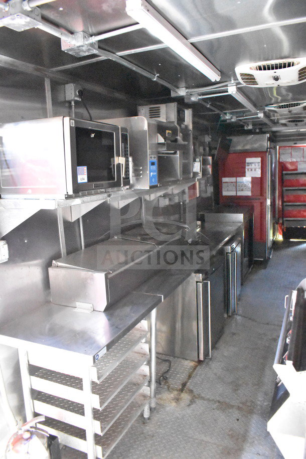 Interior of Wendy's Food Trailer with stainless steel counters, ovens, and refrigeration units, showing clean and operational equipment.
