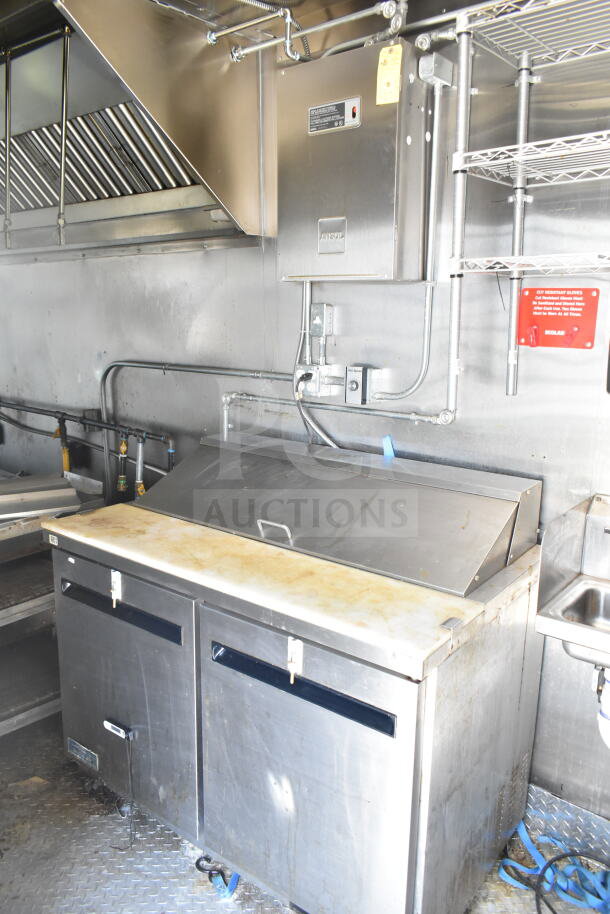 Diamond Cargo 8.5'x24' food trailer interior, showing stainless steel prep table, Ansul fire system, and metal shelving.
