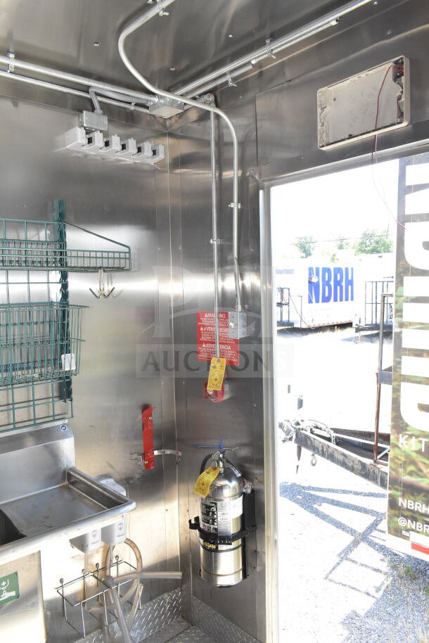 Interior of Diamond Cargo 8.5'x24' food trailer with stainless steel walls, wiring, fire extinguisher, and mounted sink. VIN: 53NBE2429M1089847.