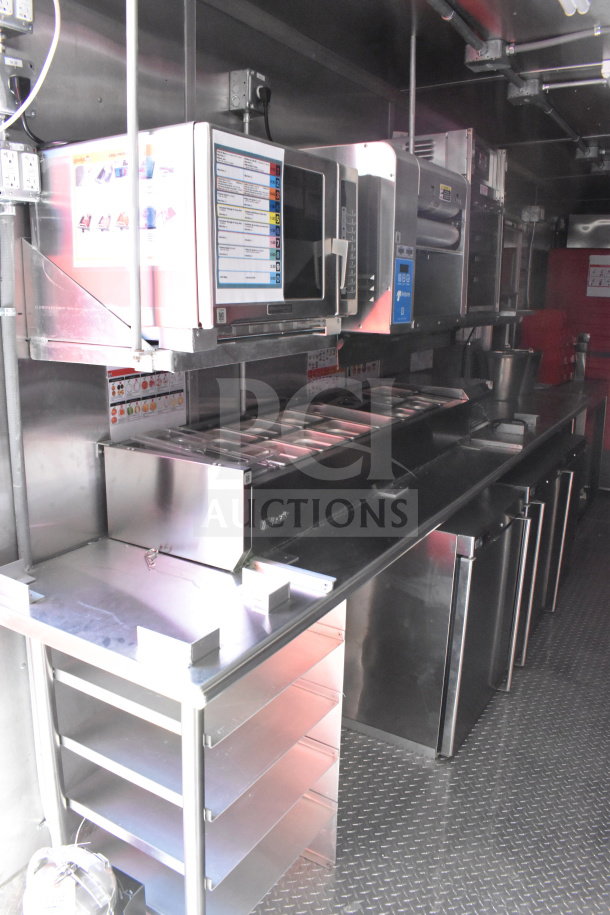 2022 Rock Solid Cargo 8.5x28 food trailer interior with CaptiveAire grease hood, Garland clamshell, and refrigeration suite.