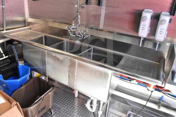 2022 Rock Solid Cargo 8.5x28 trailer sink area; stainless steel triple sink, faucet, and BioLab soap dispensers.