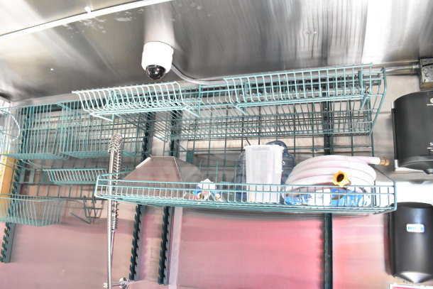 Interior shelving of 2022 Rock Solid Cargo food trailer; visible equipment includes storage racks and a security camera.