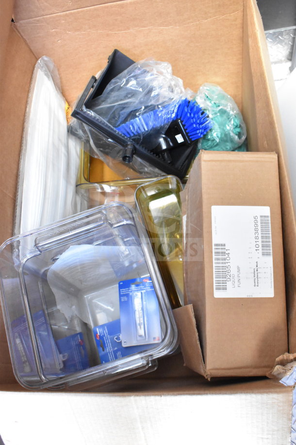 Box of assorted kitchen equipment, including plastic containers, brushes, labels, and packaging. Items appear new and unused.