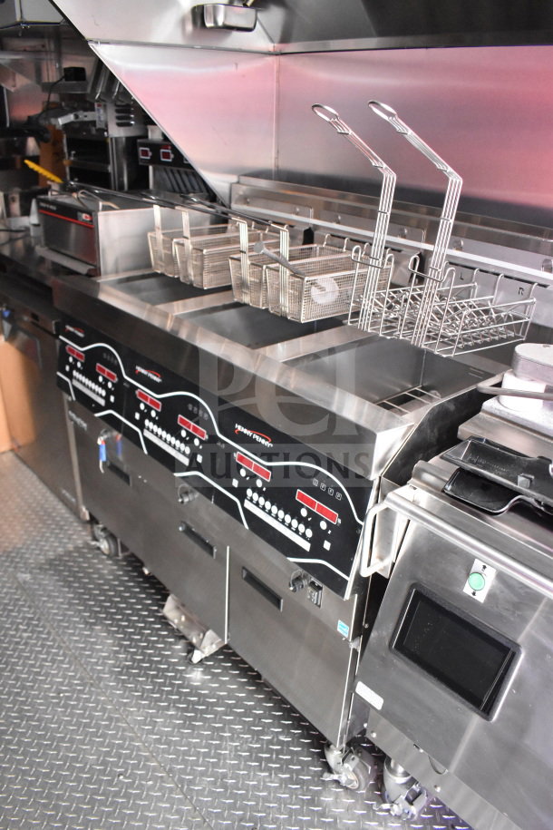 2022 Rock Solid Cargo 8.5x28 food trailer interior with Henny Penny fryer and CaptiveAire grease hood, in excellent condition.