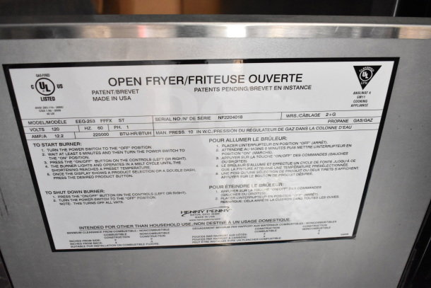 Label on Henny Penny fryer in 2022 Rock Solid Cargo food trailer. Includes model EEG-253, voltage, and operation instructions.