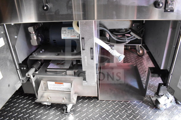 Interior of 2022 Rock Solid Cargo 8.5x28 Wendy's Food Trailer with CaptiveAire grease hood and commercial kitchen equipment.