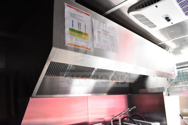 2022 Rock Solid Cargo 8.5x28 food trailer interior showing CaptiveAire grease hood with operational instruction tags.