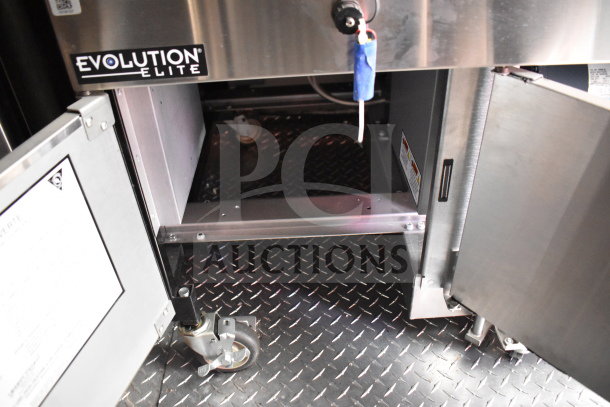 2022 Rock Solid Cargo 8.5x28 food trailer interior showing Evolution Elite equipment on diamond plate flooring.