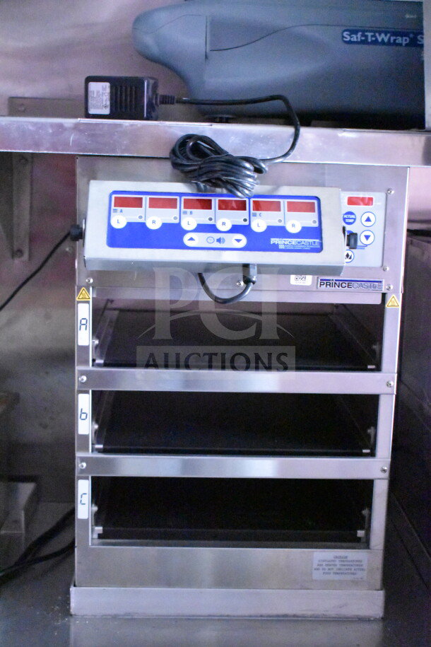 2022 Rock Solid Cargo 8.5x28 food trailer interior, featuring Prince Castle holding unit with display and shelves.