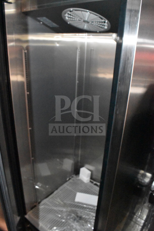 Interior of 2022 Rock Solid Cargo 8.5x28 food trailer with stainless steel finish, part of refrigeration suite.