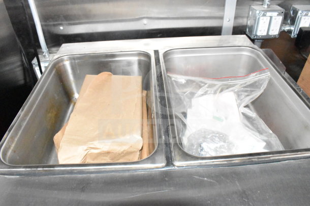 Stainless steel food preparation bins inside a 2022 Rock Solid Cargo Wendy's food trailer.