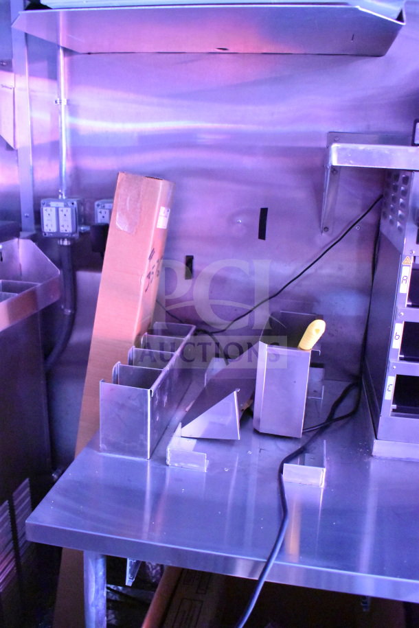 2022 Rock Solid Cargo 8.5x28 food trailer interior with stainless steel surfaces and utility outlets visible.