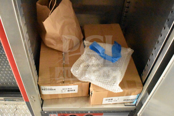 Cardboard boxes and a paper bag on a shelf inside the 2022 Rock Solid Cargo Wendy's Food Trailer. Labels visible: "G11-032, CS Wire Slide."