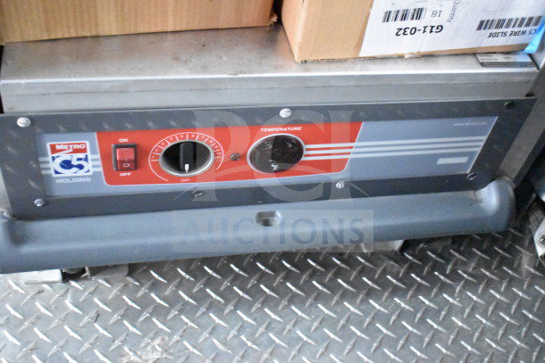 Control panel of a Metro C5 holding unit inside a 2022 Rock Solid Cargo food trailer. Features temperature dial.