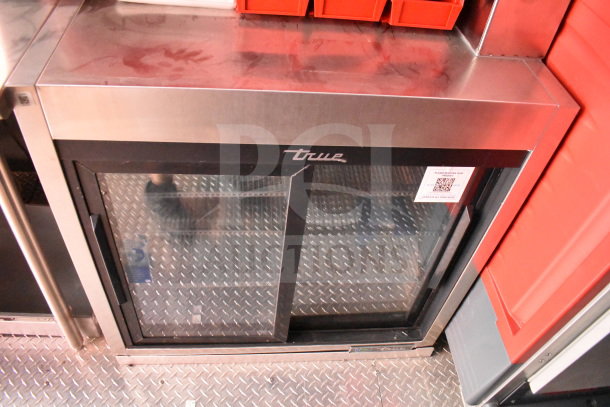 Rock Solid Cargo food trailer interior showing a True glass-door refrigerator, with labels for model and specifications.