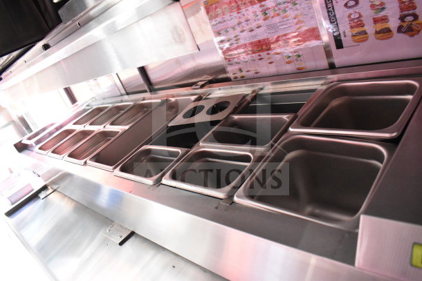 2022 Rock Solid Cargo 8.5x28 Wendy's Food Trailer interior with stainless steel prep counter, inserts, and menu display.