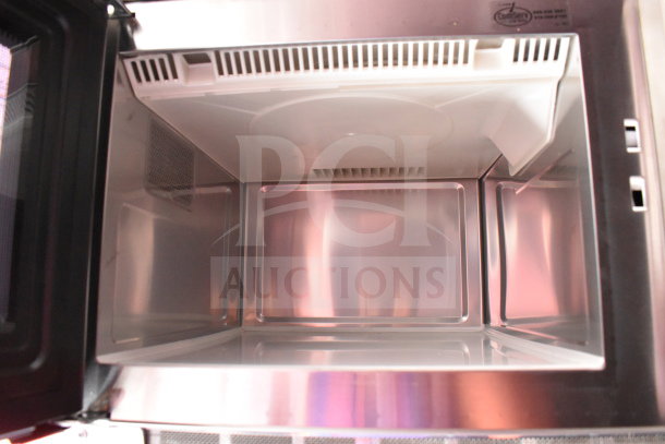 Interior view of 2022 Rock Solid Cargo food trailer appliance, showcasing stainless steel lining and ventilation system.