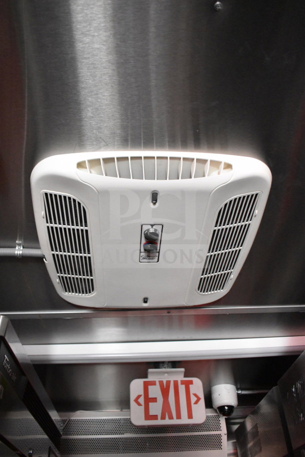 Interior of 2022 Rock Solid Cargo 8.5x28 Wendy's Food Trailer, displaying ceiling-mounted CaptiveAire grease hood and EXIT sign.