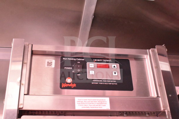 Henny Penny bun holding cabinet in 2022 Rock Solid Cargo food trailer. Features temperature controls and Wendy's branding.